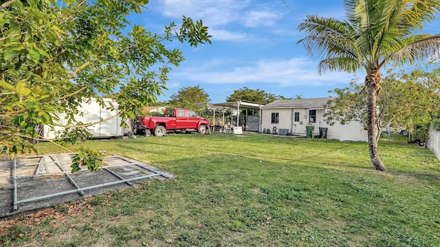 view of yard with fence and a garden