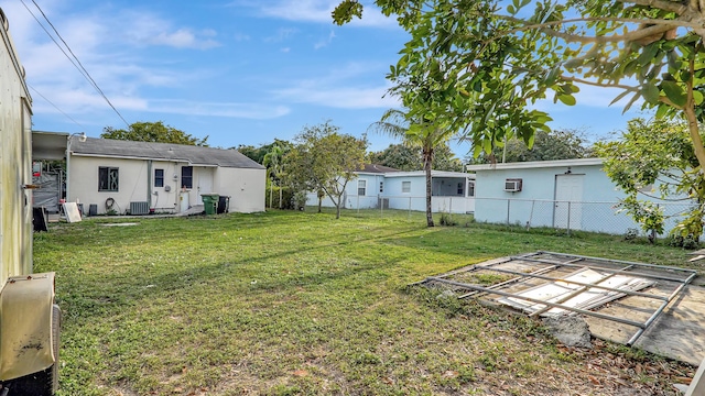 view of yard with central air condition unit and fence