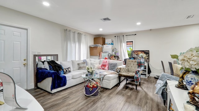 living room featuring baseboards, wood finished floors, visible vents, and recessed lighting