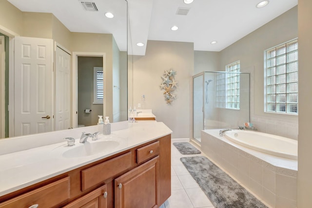 full bath with tile patterned flooring, visible vents, a shower stall, a garden tub, and vanity