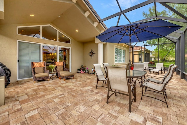 view of patio with a lanai and outdoor dining area