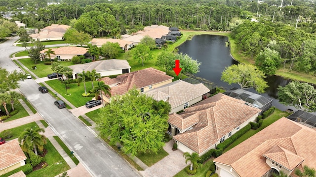 drone / aerial view featuring a residential view and a water view