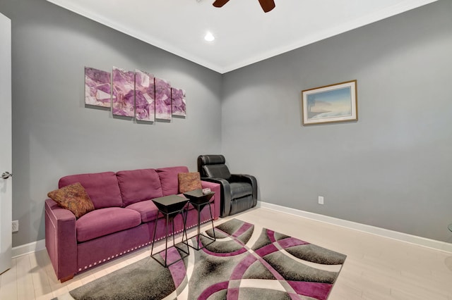 living area with a ceiling fan, wood finished floors, recessed lighting, crown molding, and baseboards