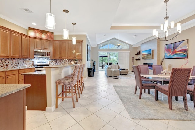 kitchen with crown molding, light tile patterned flooring, backsplash, and stainless steel appliances