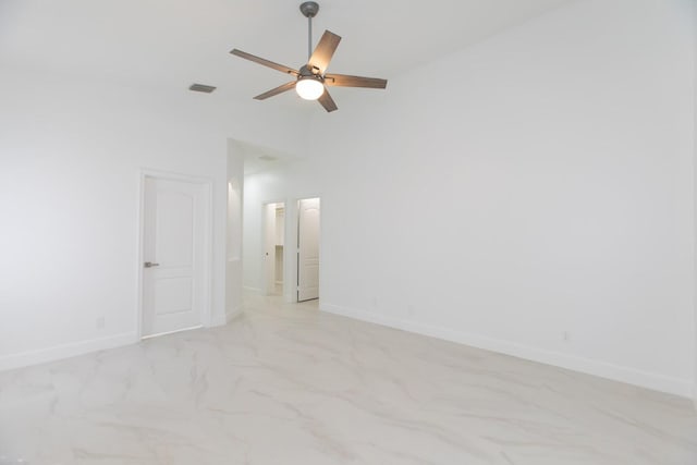unfurnished room featuring visible vents, a ceiling fan, marble finish floor, and baseboards