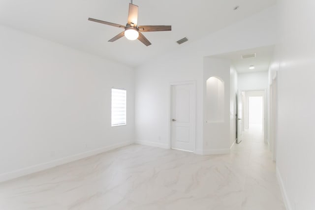 spare room with lofted ceiling, baseboards, and marble finish floor