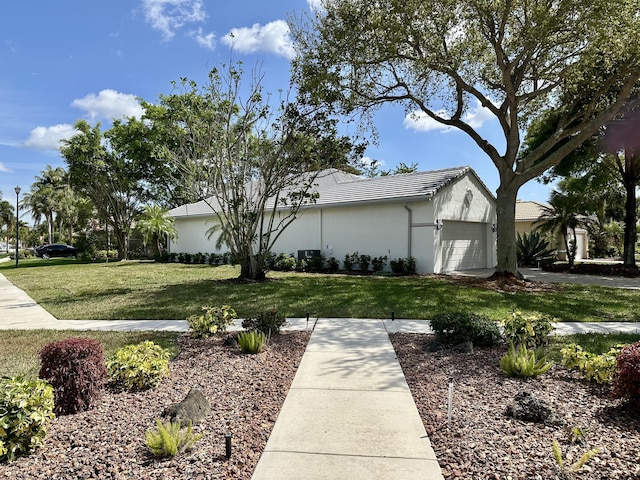 view of property exterior with a yard, an attached garage, a tile roof, and stucco siding