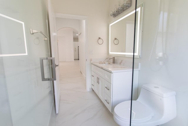 bathroom featuring vanity, toilet, and marble finish floor