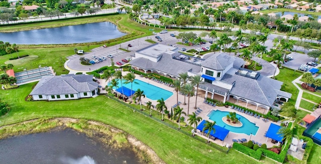 drone / aerial view with a water view and a residential view