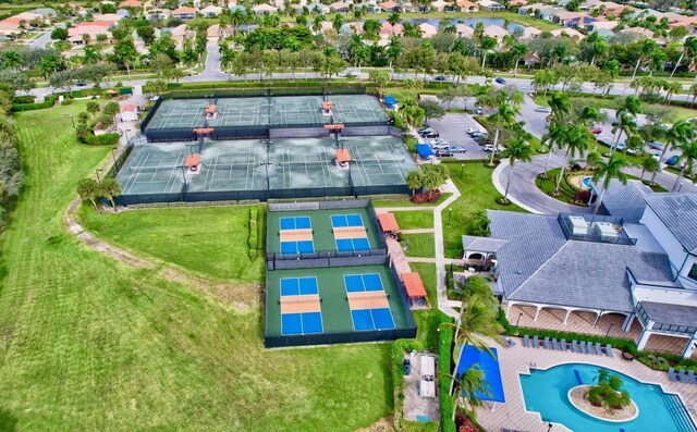 community pool with a patio area, fence, and a gazebo