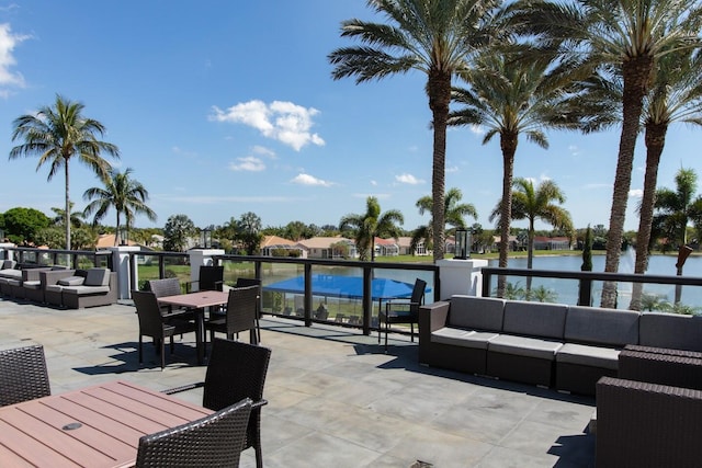 view of patio / terrace with outdoor lounge area, outdoor dining area, and a water view