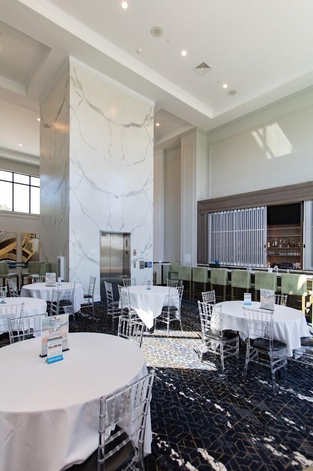 dining area featuring visible vents, marble finish floor, recessed lighting, crown molding, and stone wall