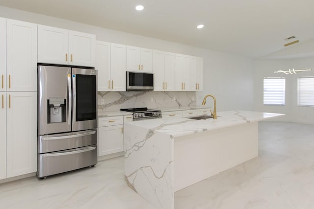 kitchen featuring marble finish floor, appliances with stainless steel finishes, white cabinets, and a sink