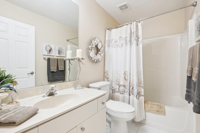 bathroom featuring a textured ceiling, toilet, vanity, visible vents, and tile patterned floors