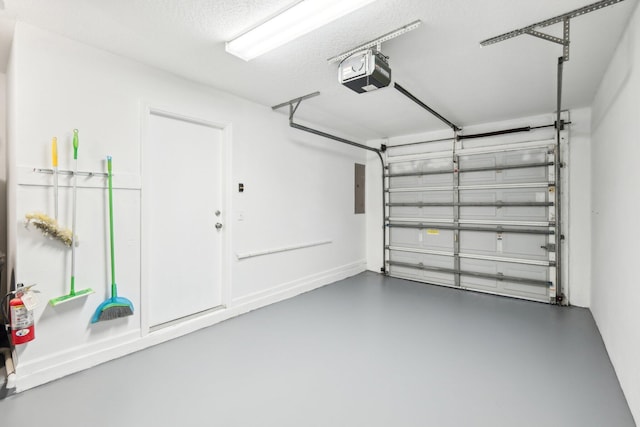 garage featuring a garage door opener and electric panel