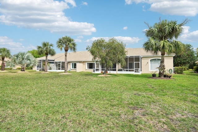 rear view of house featuring a lawn