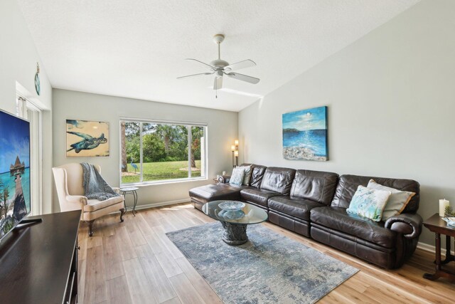 bedroom featuring ceiling fan, light wood-style flooring, and baseboards