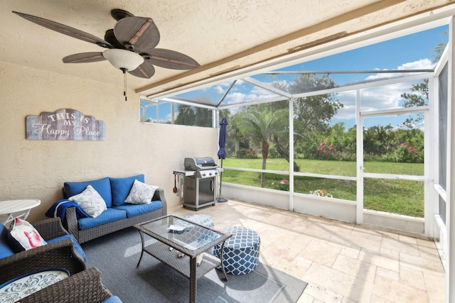 sunroom featuring ceiling fan