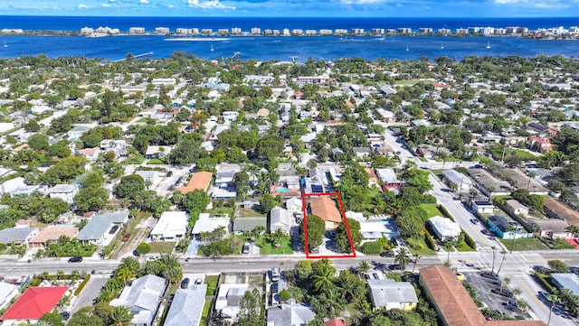 drone / aerial view featuring a residential view and a water view