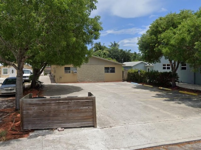 exterior space with a fenced front yard and uncovered parking