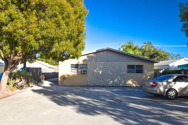 view of side of home with fence