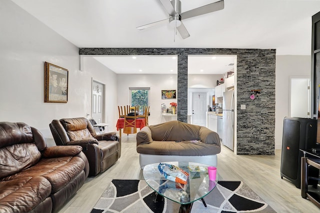 living room with a ceiling fan and light wood-style floors