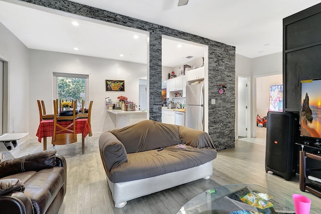 living area featuring light wood-style floors and recessed lighting