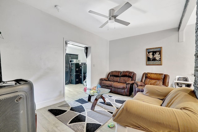 living area with ceiling fan, light wood-style flooring, and baseboards