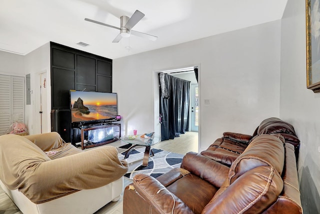 living room with a ceiling fan, light wood-type flooring, and visible vents