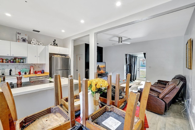 dining room with ceiling fan, recessed lighting, and light wood-style floors