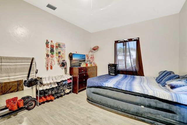 bedroom with wood finished floors and visible vents