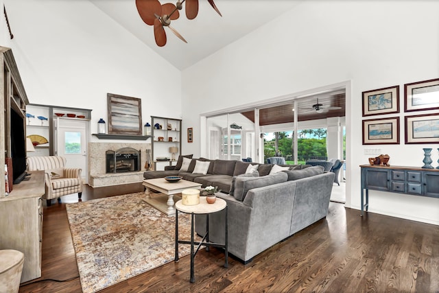 living room with a ceiling fan, high vaulted ceiling, and dark wood finished floors