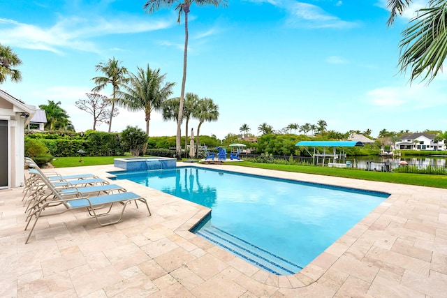 view of pool featuring a patio area, a pool with connected hot tub, and fence