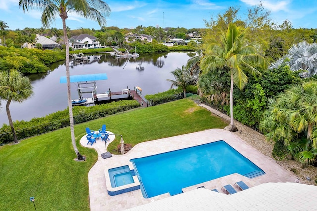 view of swimming pool with a yard, a water view, a patio area, a boat dock, and boat lift