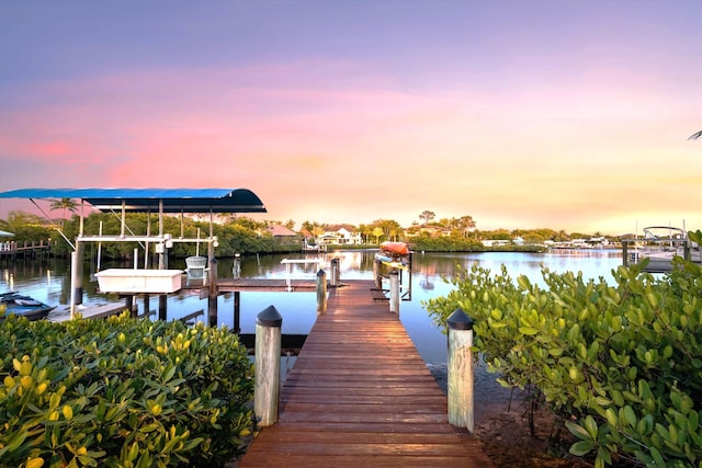 dock area featuring boat lift and a water view