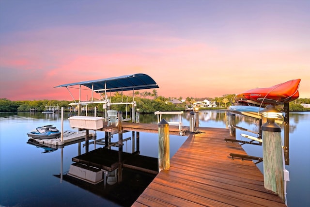 dock area featuring boat lift and a water view