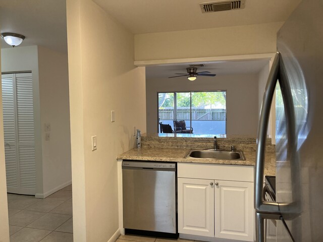 kitchen with light tile patterned floors, a sink, visible vents, white cabinets, and appliances with stainless steel finishes