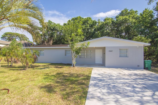 ranch-style house with driveway and a front lawn