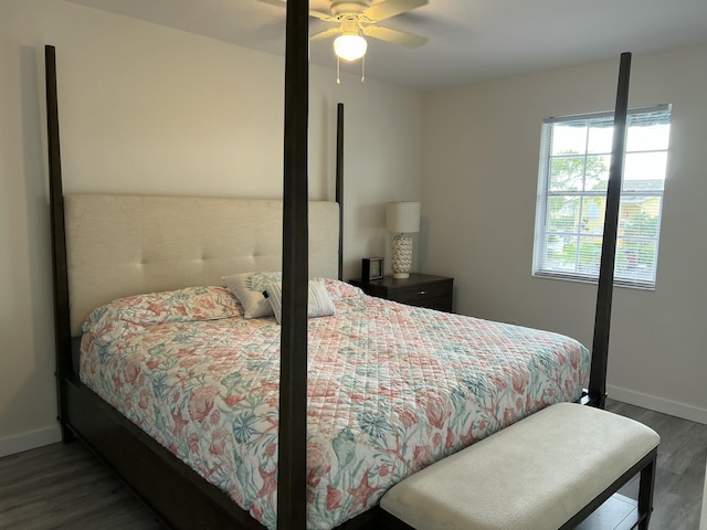 bedroom with ceiling fan, baseboards, and wood finished floors