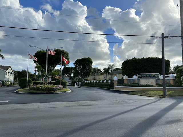 view of road featuring street lights and a residential view