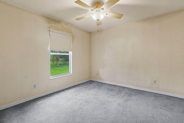 carpeted empty room featuring a ceiling fan and a textured ceiling