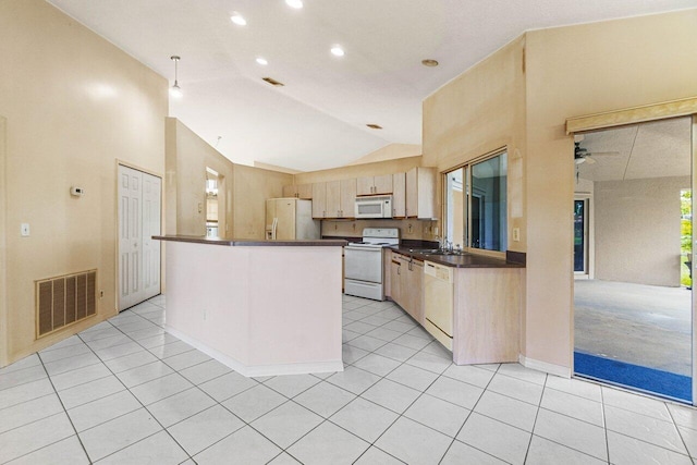 kitchen with dark countertops, white appliances, visible vents, and light tile patterned floors