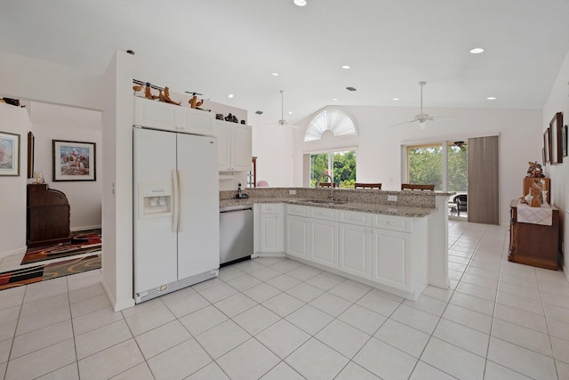 3190 SE Carrick Green Ct, Port Saint Lucie, FL 34952 - kitchen featuring white refrigerator with ice dispenser, dishwasher, ceiling fan, vaulted ceiling, and a sink