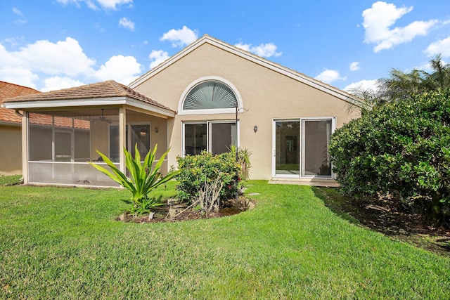 3190 SE Carrick Green Ct, Port Saint Lucie, FL 34952 - rear view of property with stucco siding, a lawn, and a sunroom