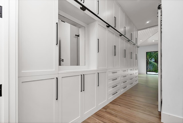 hall with recessed lighting and light wood-style flooring