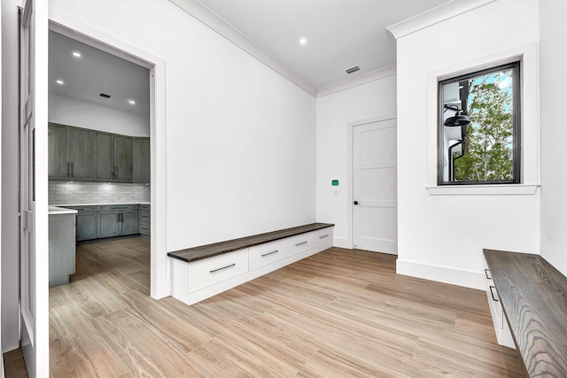 mudroom with crown molding, recessed lighting, visible vents, light wood-style flooring, and baseboards