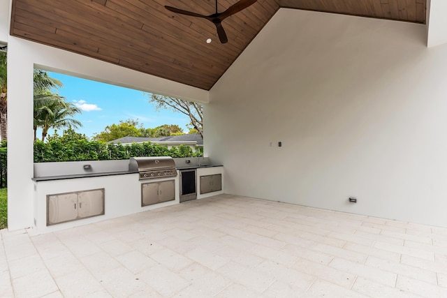 view of patio / terrace with ceiling fan, an outdoor kitchen, and area for grilling