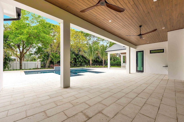 view of patio with a pool with connected hot tub, a fenced backyard, and a ceiling fan