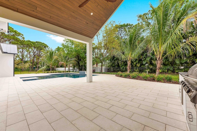 view of patio featuring ceiling fan, fence private yard, and a fenced in pool