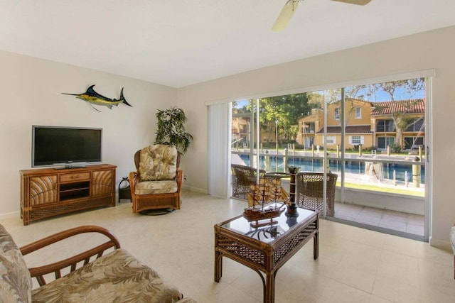 living room featuring ceiling fan and baseboards